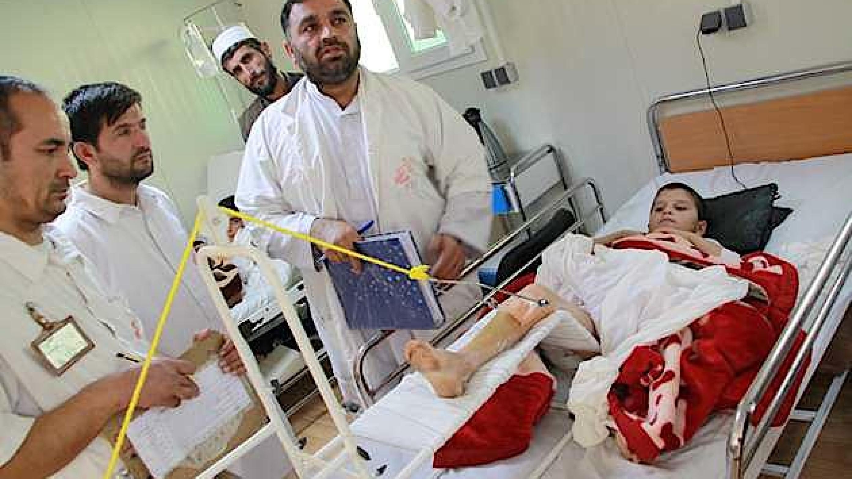 Stuegang med afghansk læge, sygeplejerske og fysioterapeut. I baggrunden en ”caretaker” for nabopatienten. Caretaker'en er en pårørende, der tager sig af patientens basale pleje. (Privatfoto)