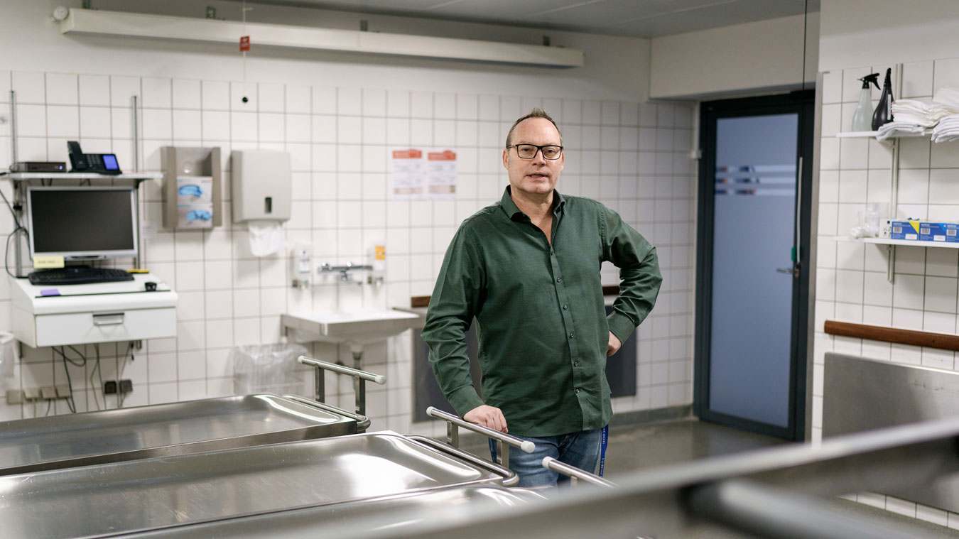 Ole Ingemann Hansen i ’morguen’, hvor ligene modtages ved ankomsten til instituttet. Døren i baggrunden leder ud til ambulance­parkeringen, og fra rummet er der desuden direkte adgang til både CT-skanneren, kølerummet og sektionsstuerne. Foto: Martin Dam Kristensen