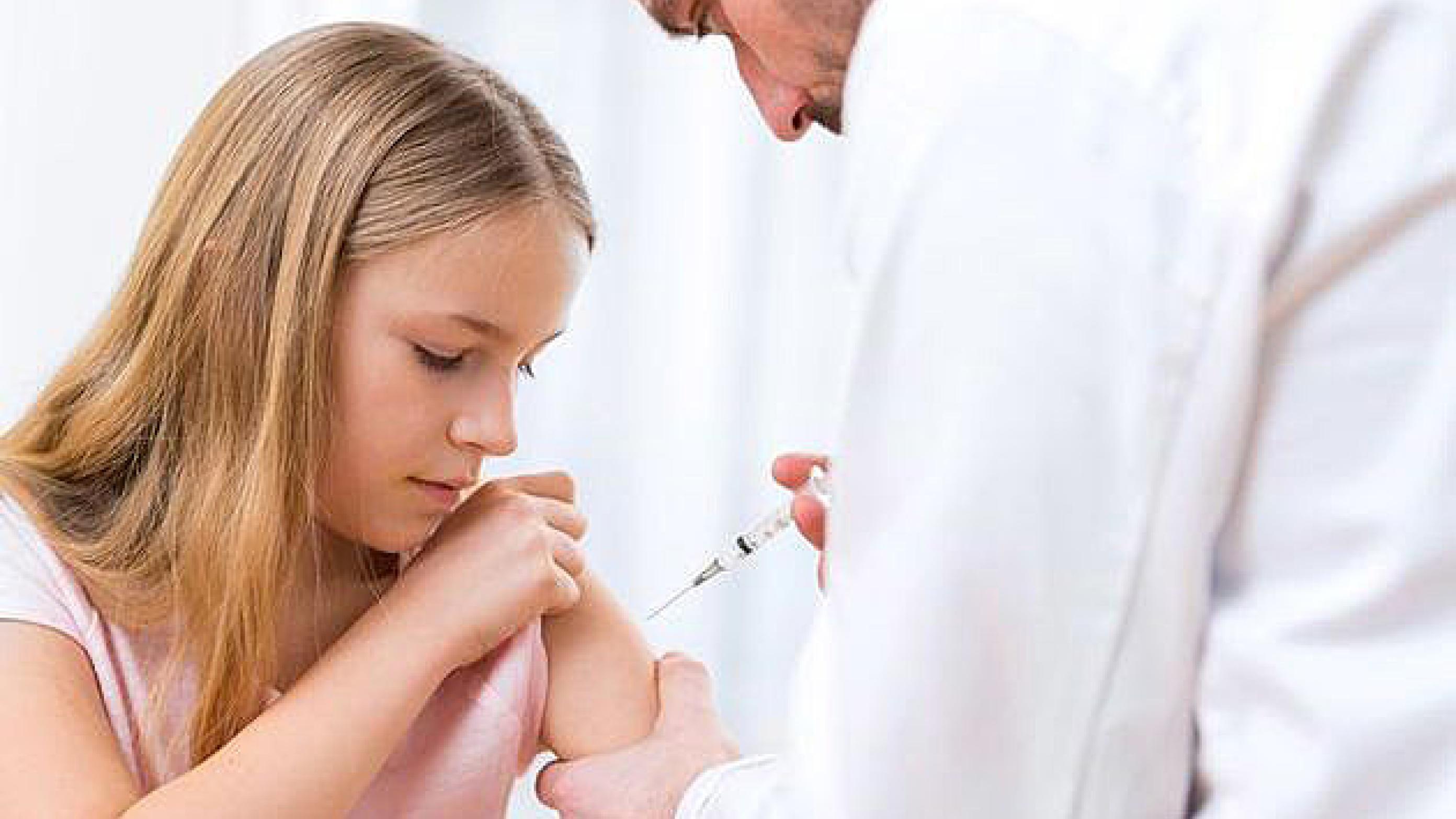 View of a Young little girl  being vaccinated at the doctor