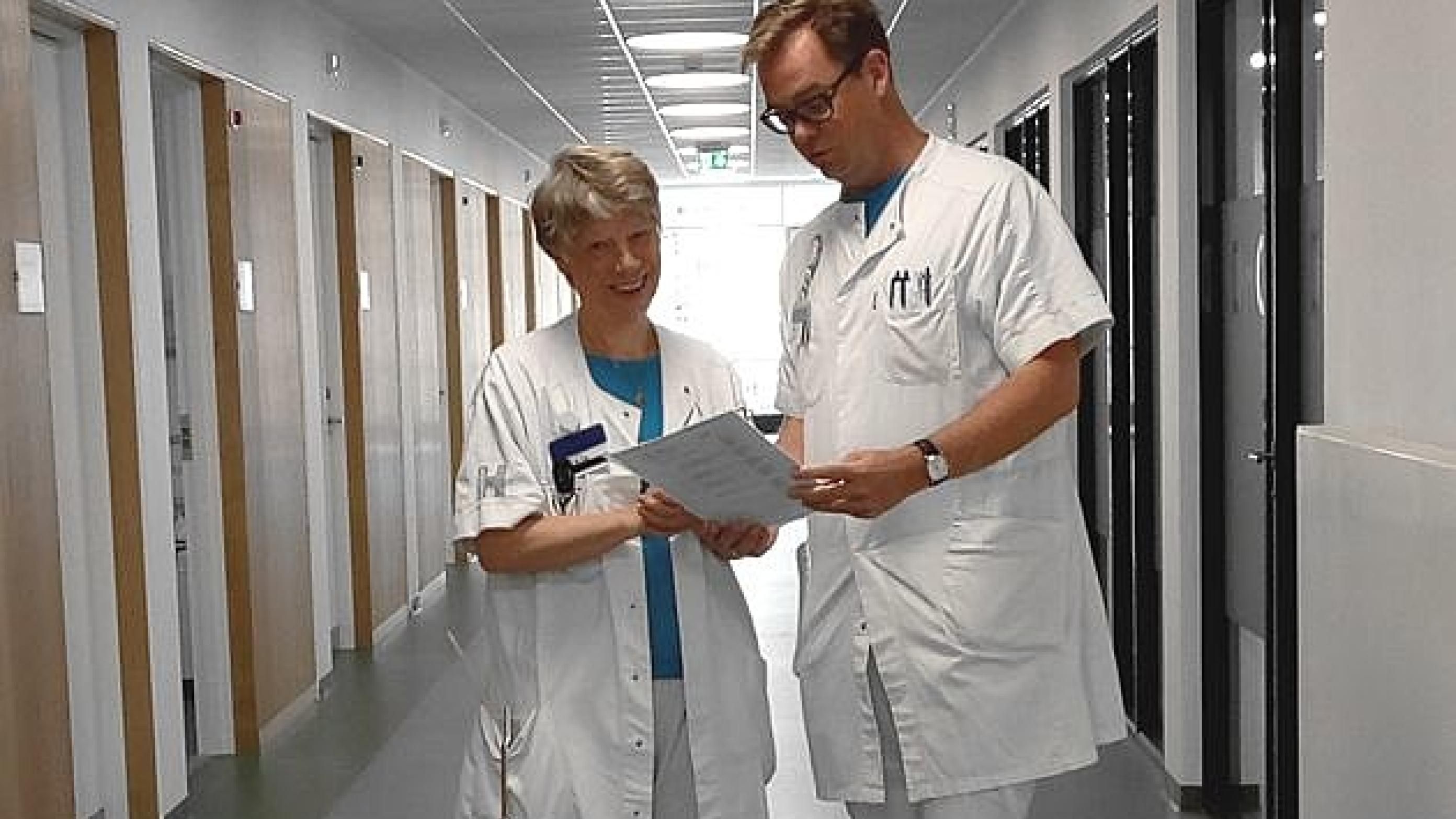 Afdelingslæge Jakob Møller Hansen konferer en patient med Hovedpinecenterets leder, Rigmor Jensen. Privat foto.