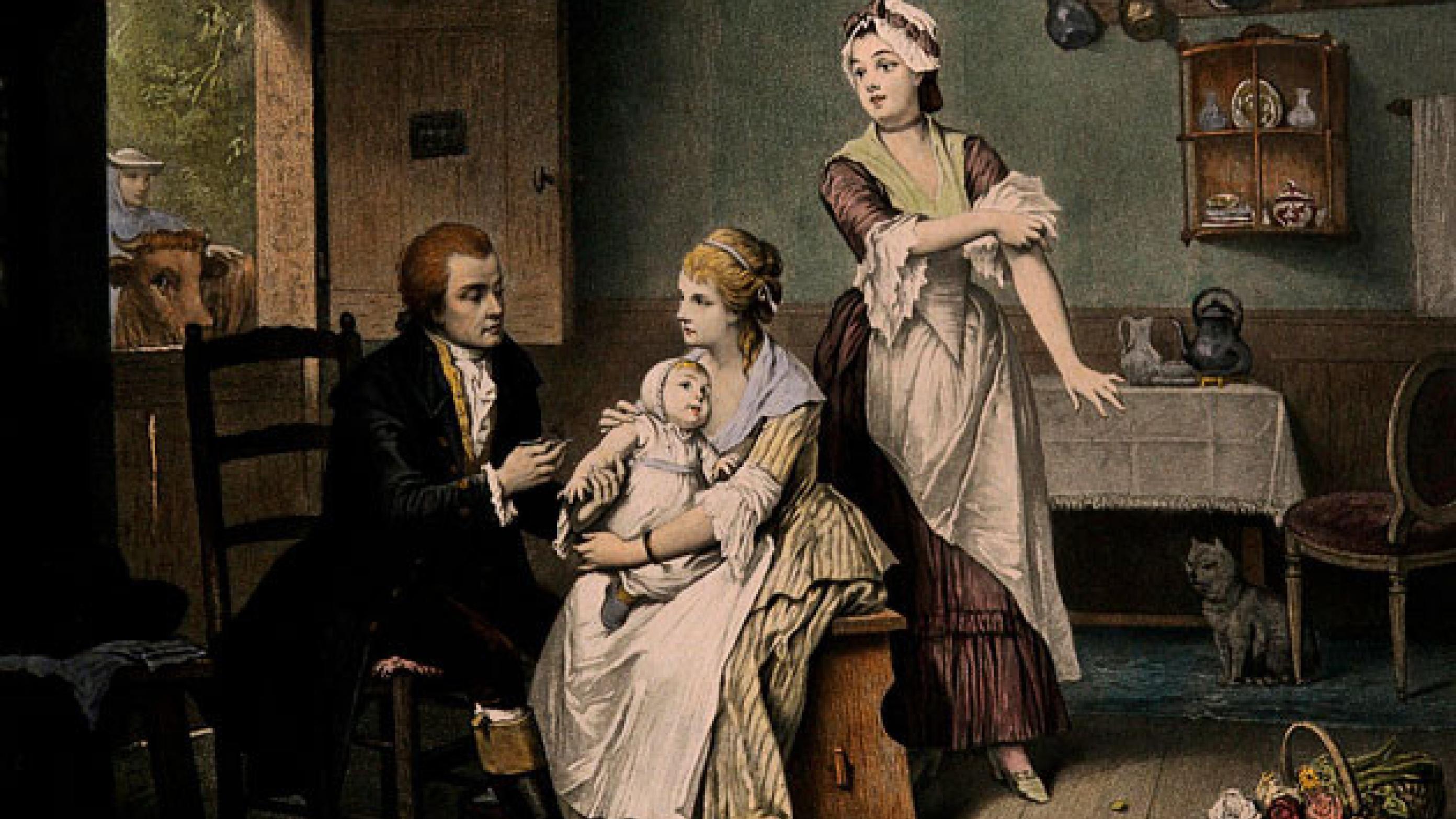 Edward Jenner, k vaccinerer sin søn, mens hans kone holder ham, og tjenestepigen ruller ærmerne op. Farvelagt radering, 1800-tallet. The Wellcome Collection.